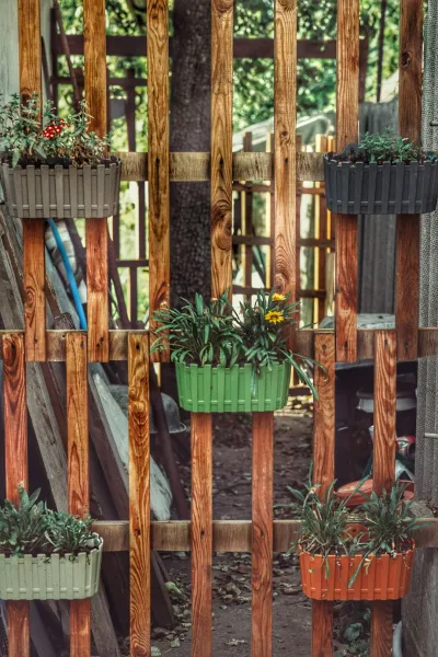 create a vertical garden using vintage wooden pallets and sustainable planters setup